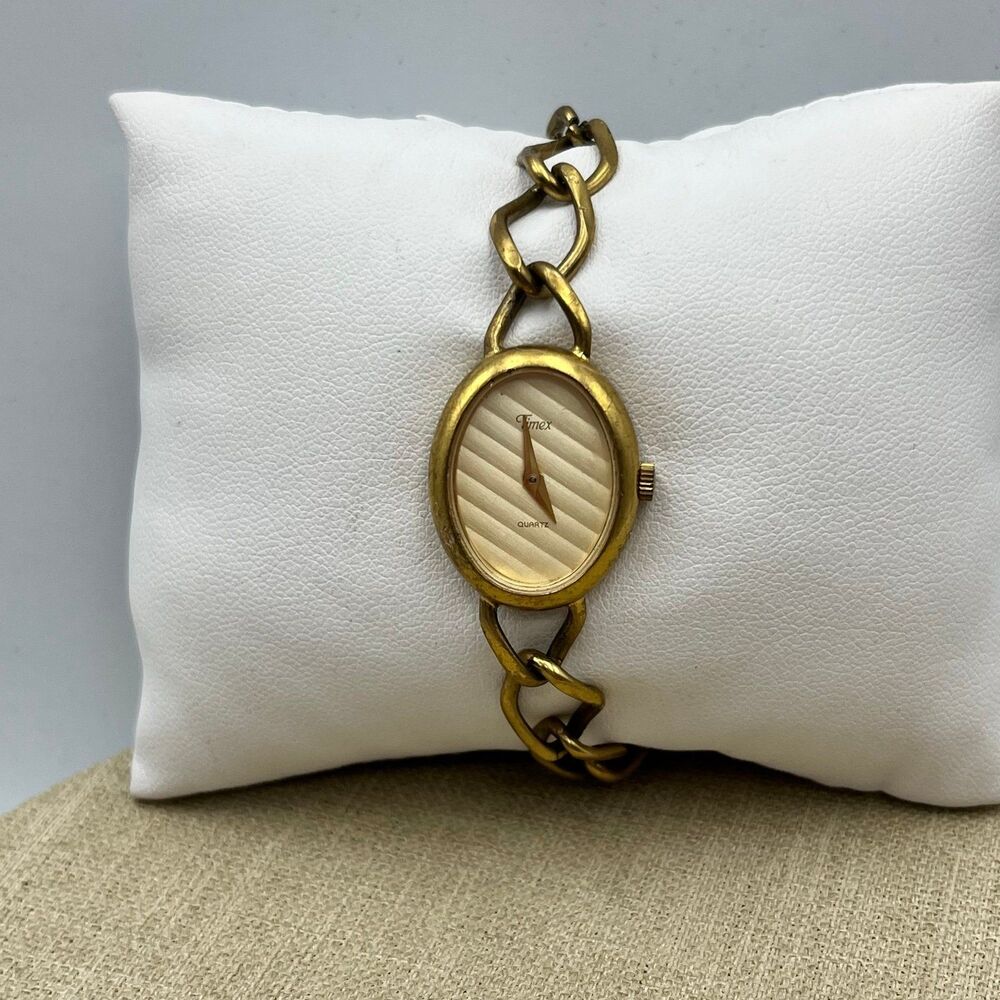Women's Timex dress watch. Mid century modern Gold oval face with lined design.
